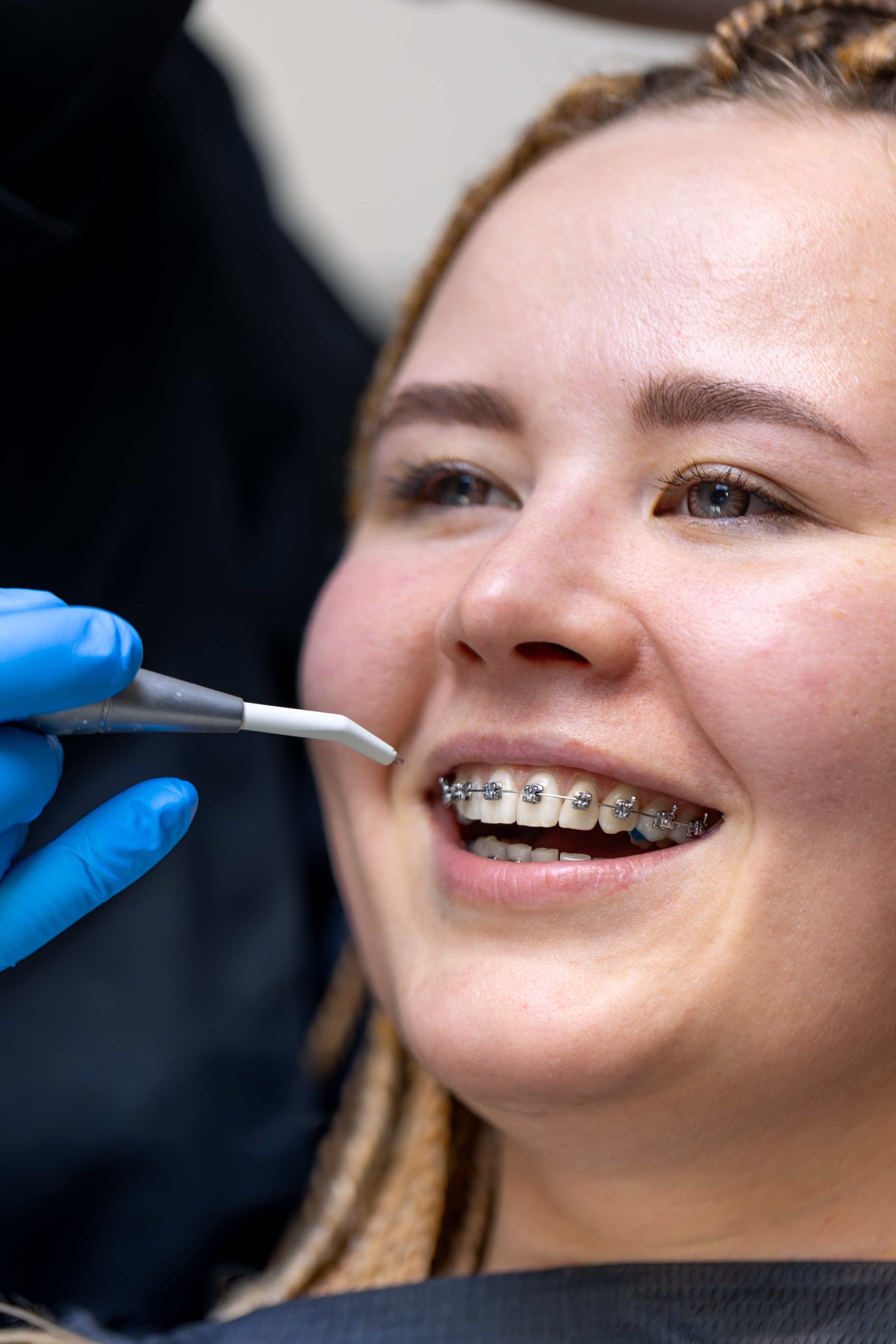 Dentist treating patient with braces